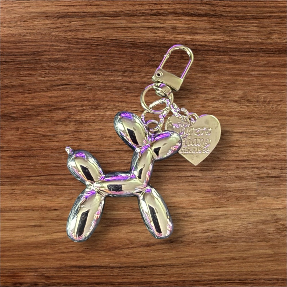 Bright Silver Balloon Dog Keychain with Heart Charm.